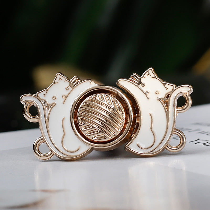 White cat vintage hanfu metal buttons close-up, ridged center disc and 4 gold loops