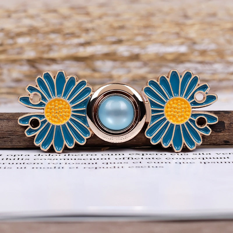 Daisy metal pair buttons with blue petals, yellow center bead discs, and circular snap backing