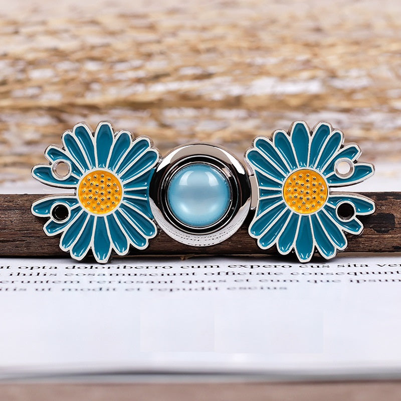 Daisy metal pair buttons, blue enamel flowers with yellow centers and two-hole mounting backs