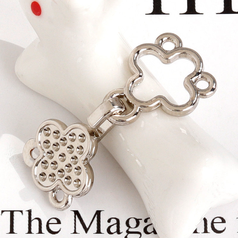 Silver-toned four-leaf clover metal hook button pair with crystal-studded face
