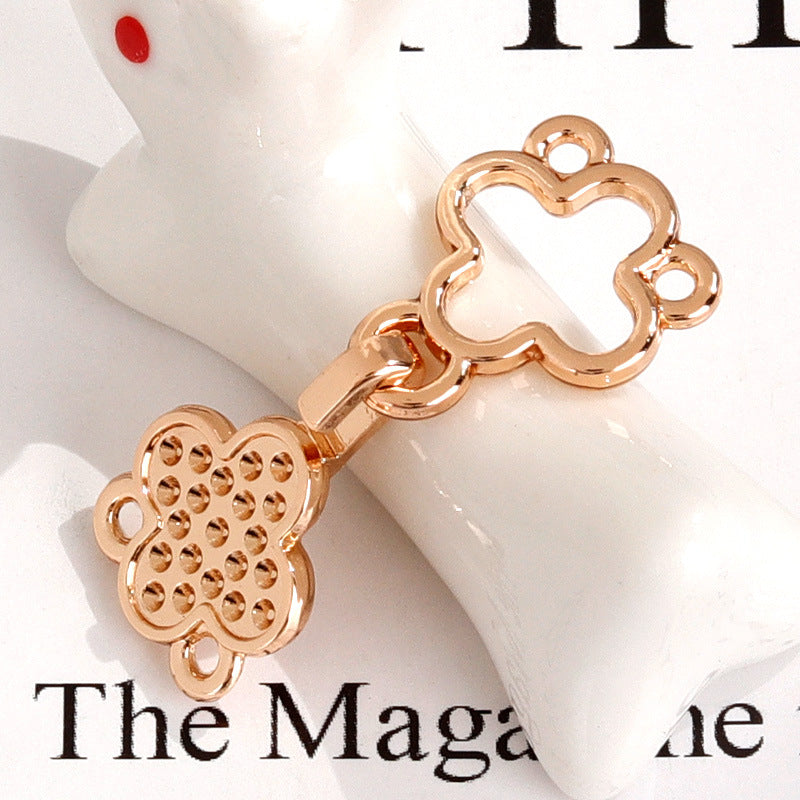 Rose gold four-leaf clover metal pair hook button with faceted crystal detail
