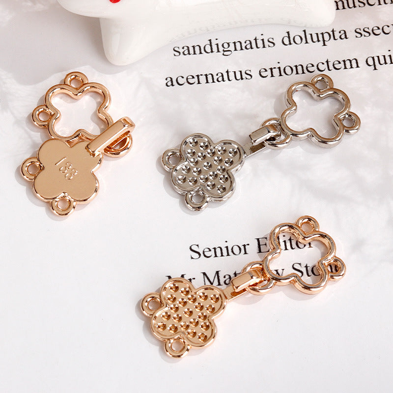 Four-leaf clover hook buttons in rose gold and silver tones, crystal-studded centers