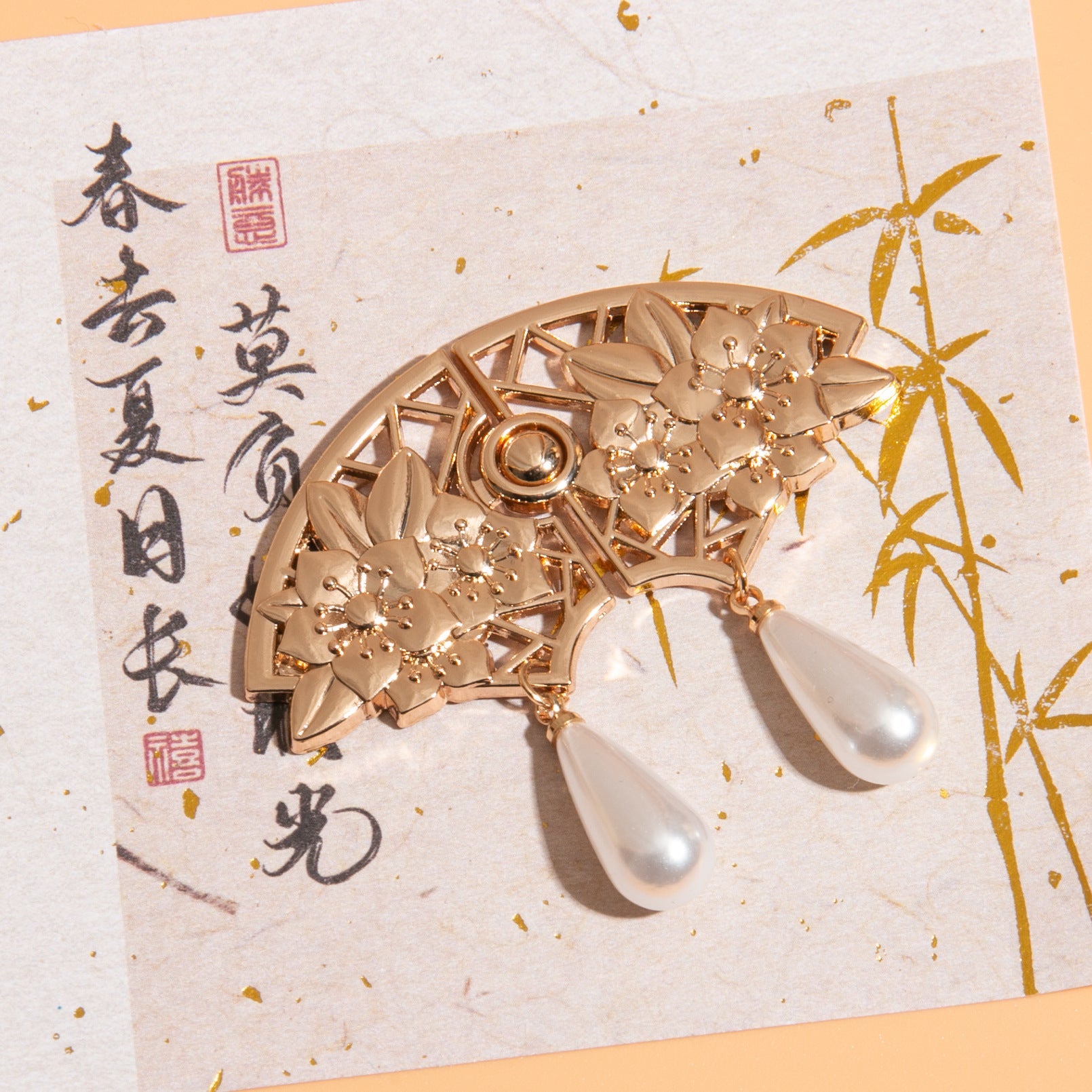 Light Gold fan-shaped Chinese frog button with round center ring and two pearl teardrops