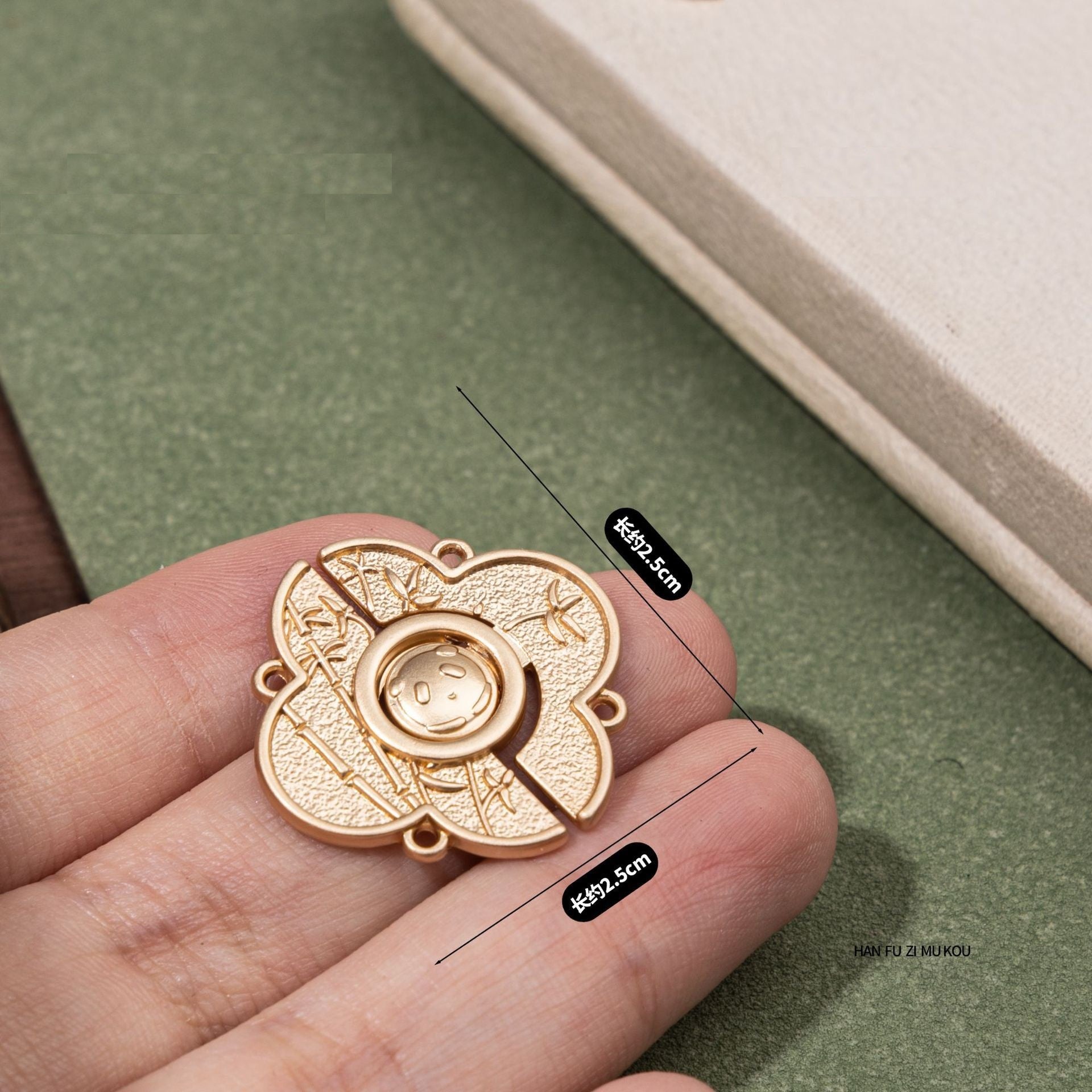 2.5 cm panda metal button on hand, gold-tone outer ring, four holes
