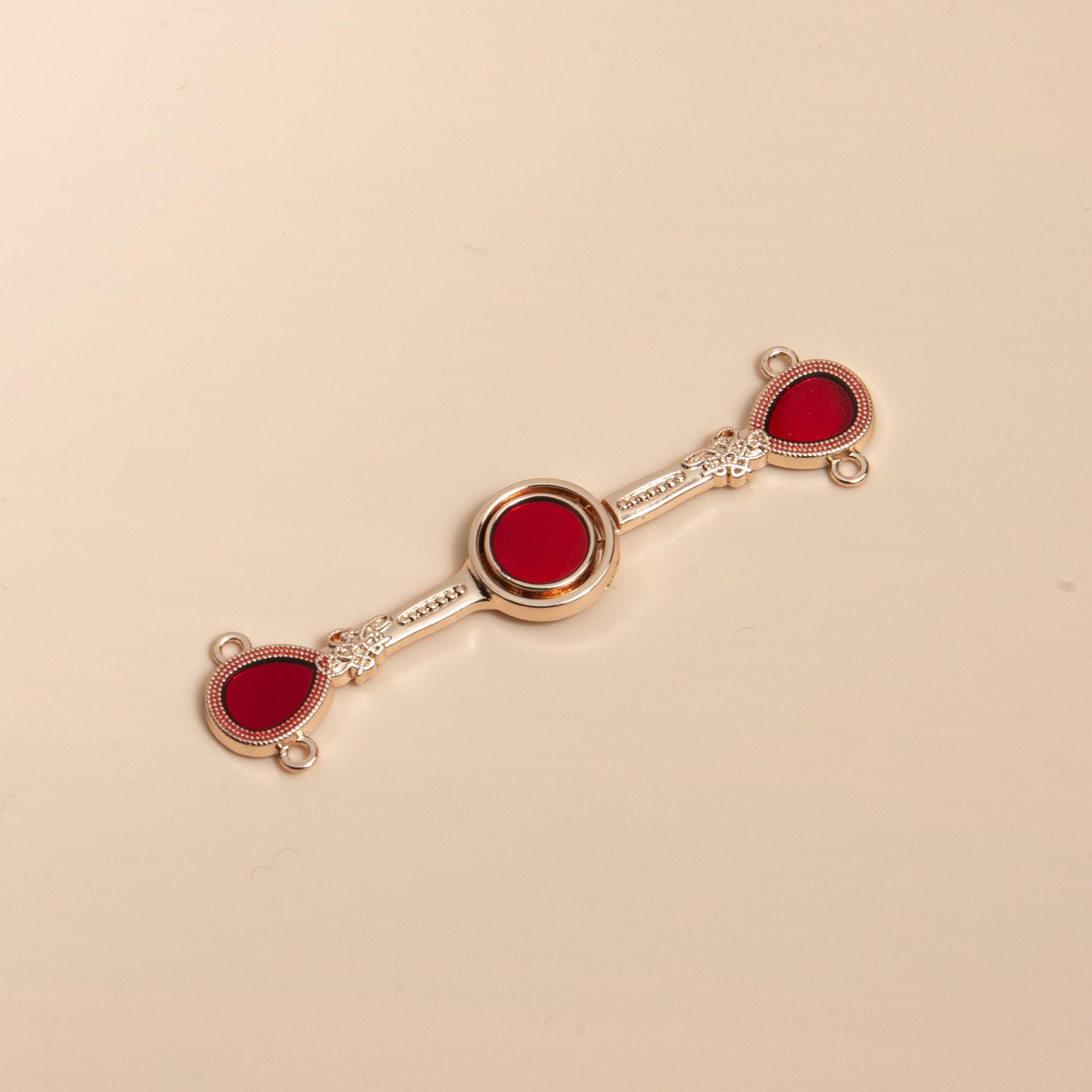 Gold-tone Chinese frog button bar with red enamel discs, no tassels