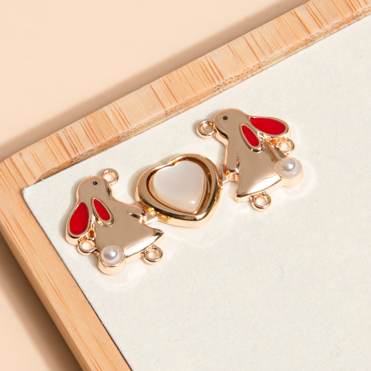 Gold metal frog buttons with red enamel heart detail, 12-pack
