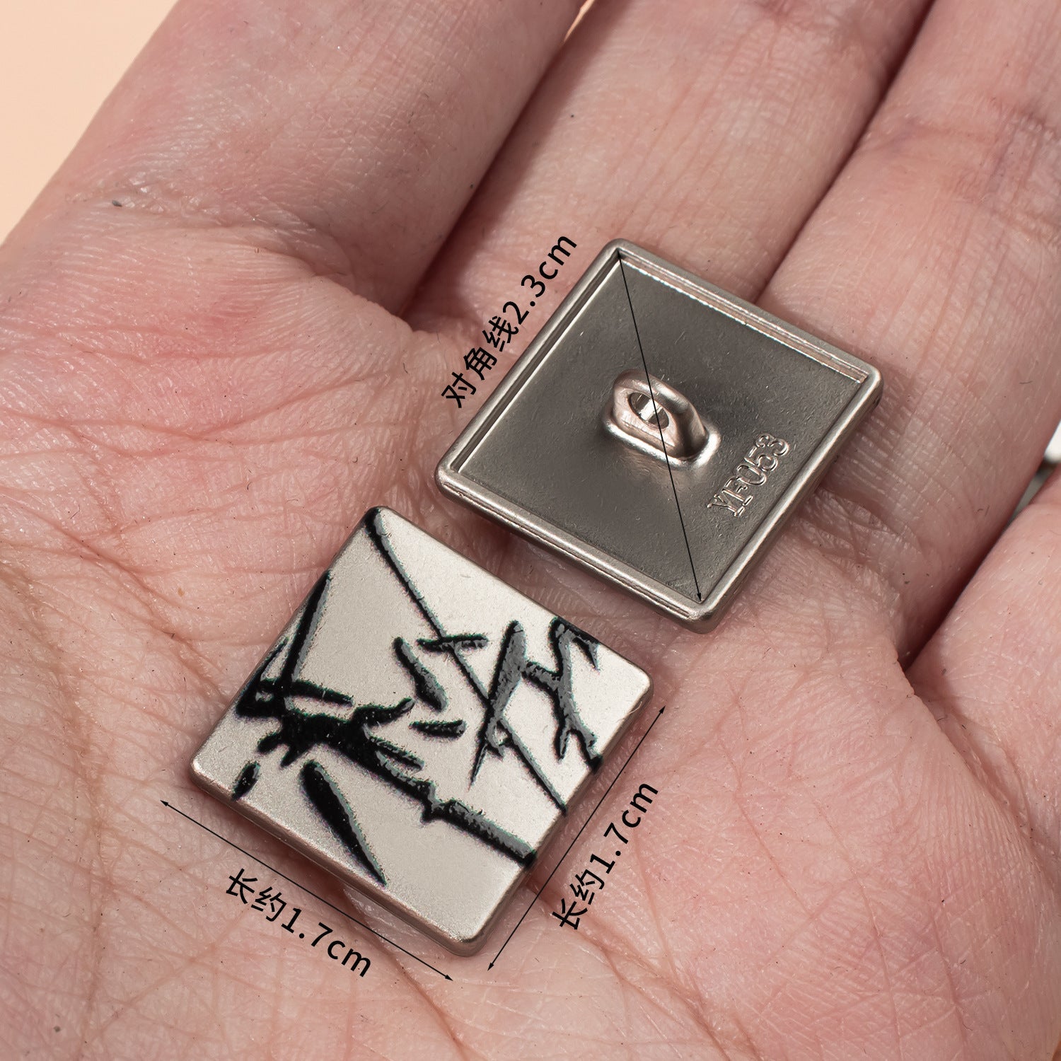 1.7cm square button on palm: white front with black ink design, metal back