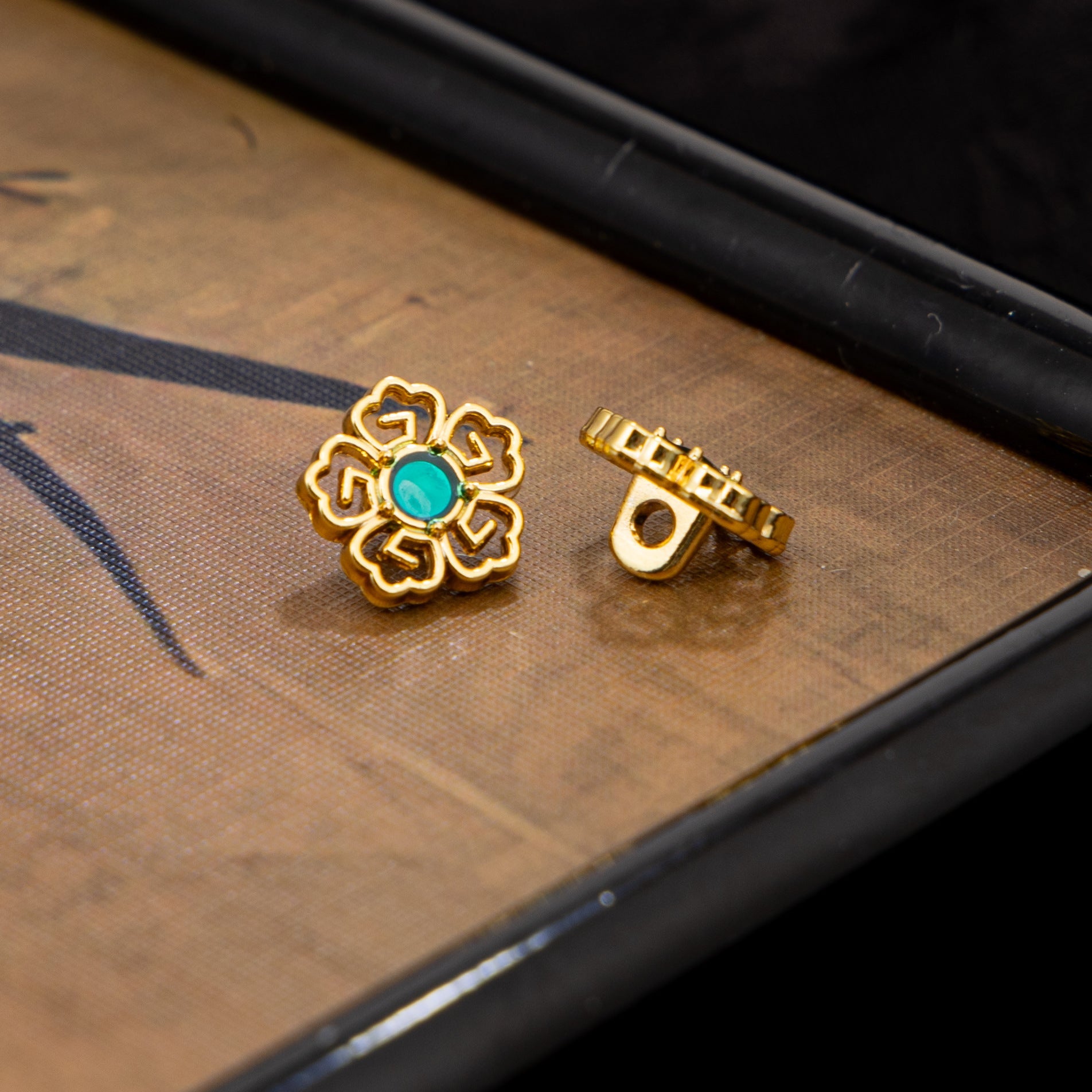 Gold-tone floral Chinese cufflinks with blue-green stone and clasp back