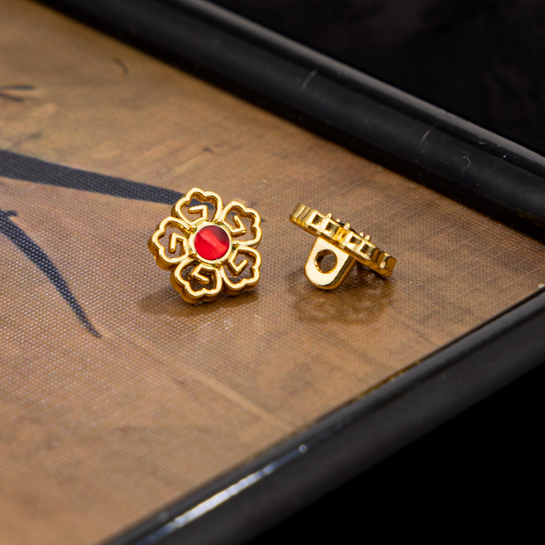 Gold-tone floral Chinese cufflinks with red stone and clasp back