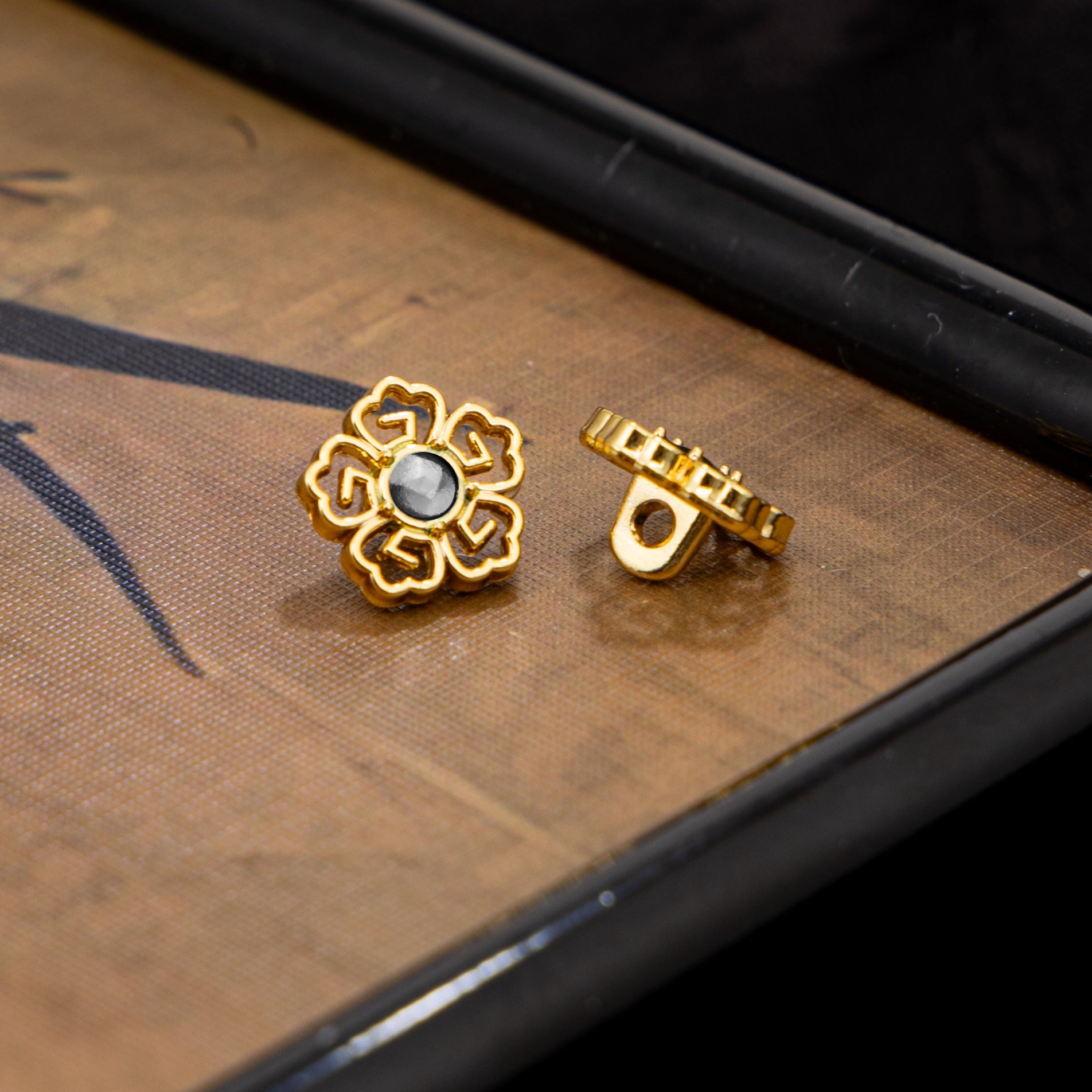 Silver-tone floral Chinese cufflinks with light center and clasp back