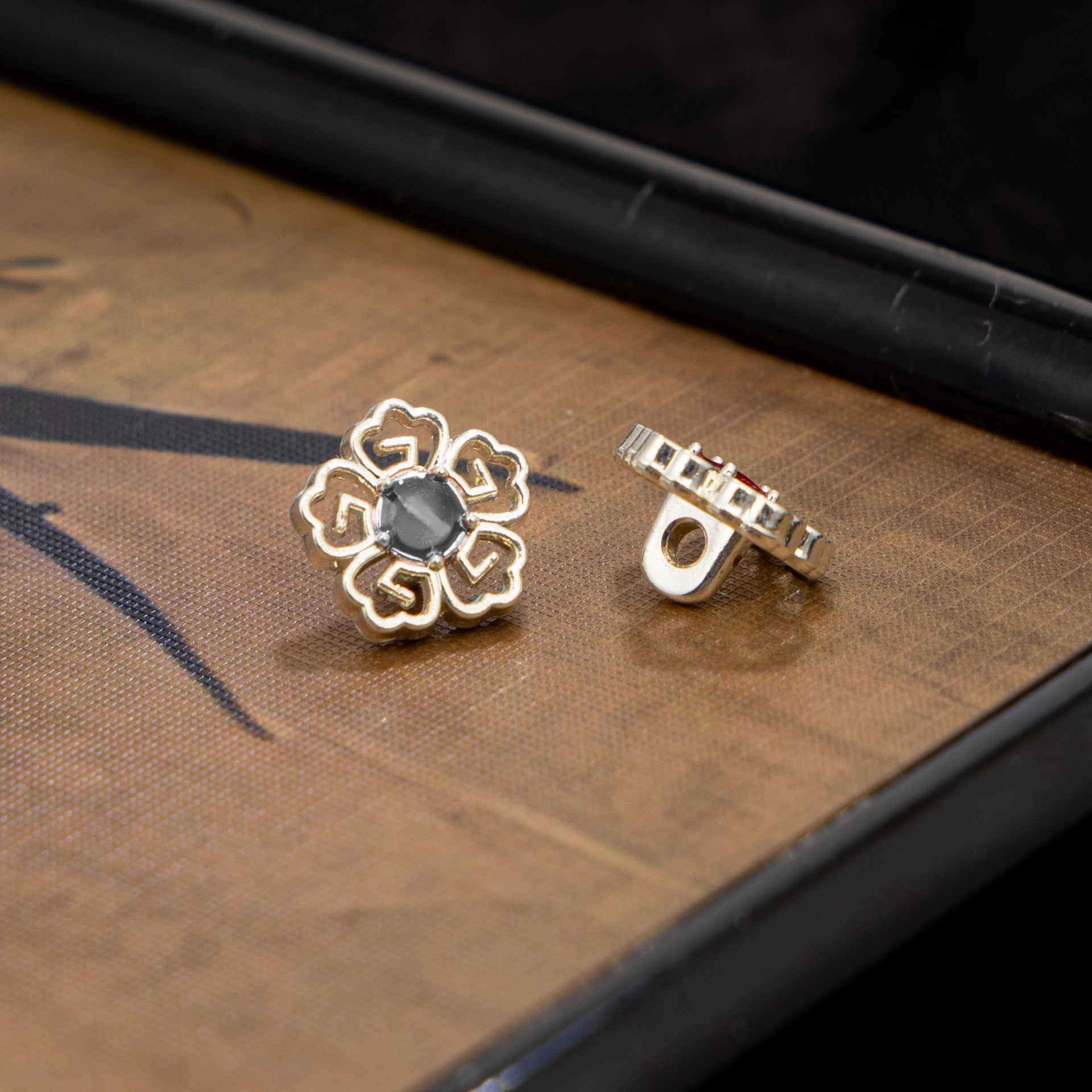 Vintage floral metal cufflinks, gold-tone with dark center gemstone detail