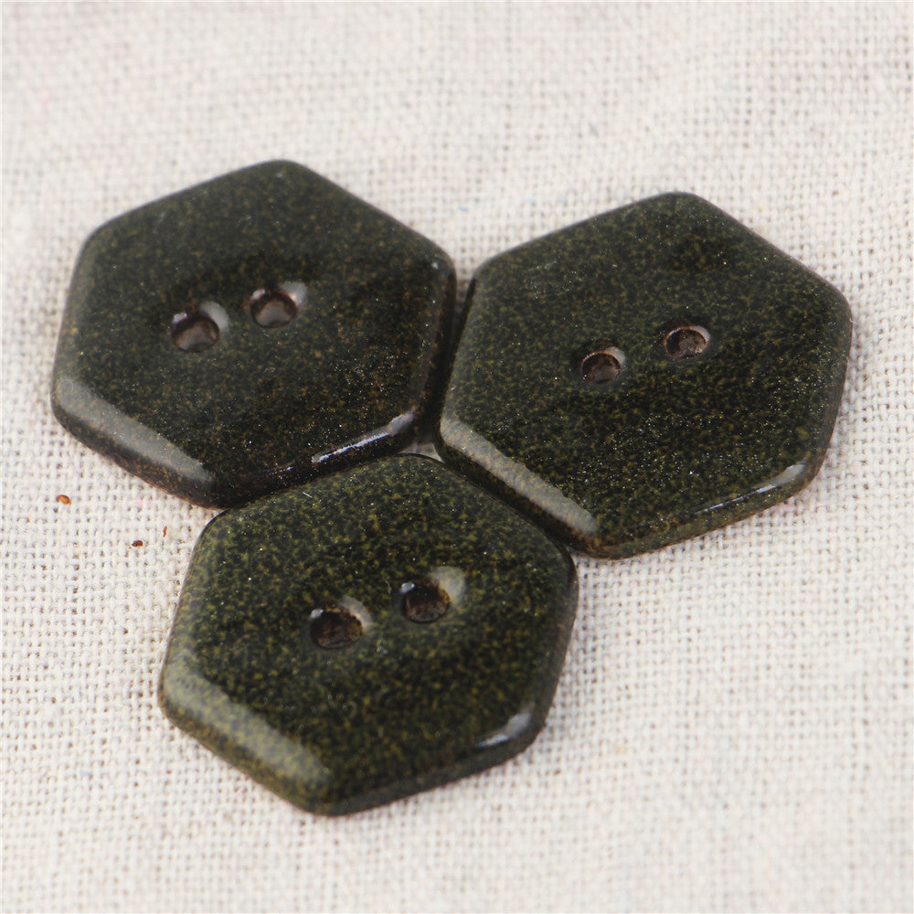 Three hexagonal 2-hole ceramic buttons, speckled dark marble pattern