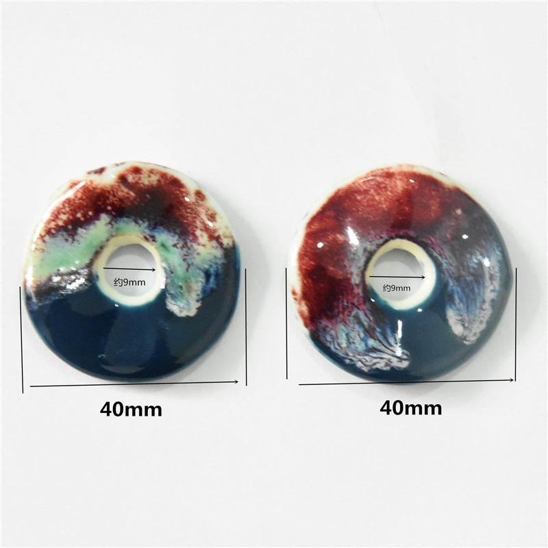 40mm round ceramic ornament pendant, dark blue with red/green splatter, center hole Ø9mm.