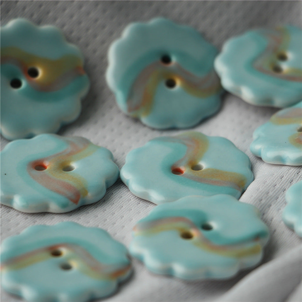 Light blue ceramic buttons with yellow center stripe, two holes (6-pack)
