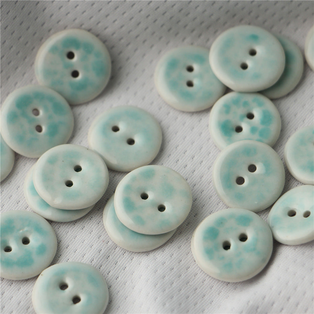 Round 2-hole ceramic buttons, light blue speckle