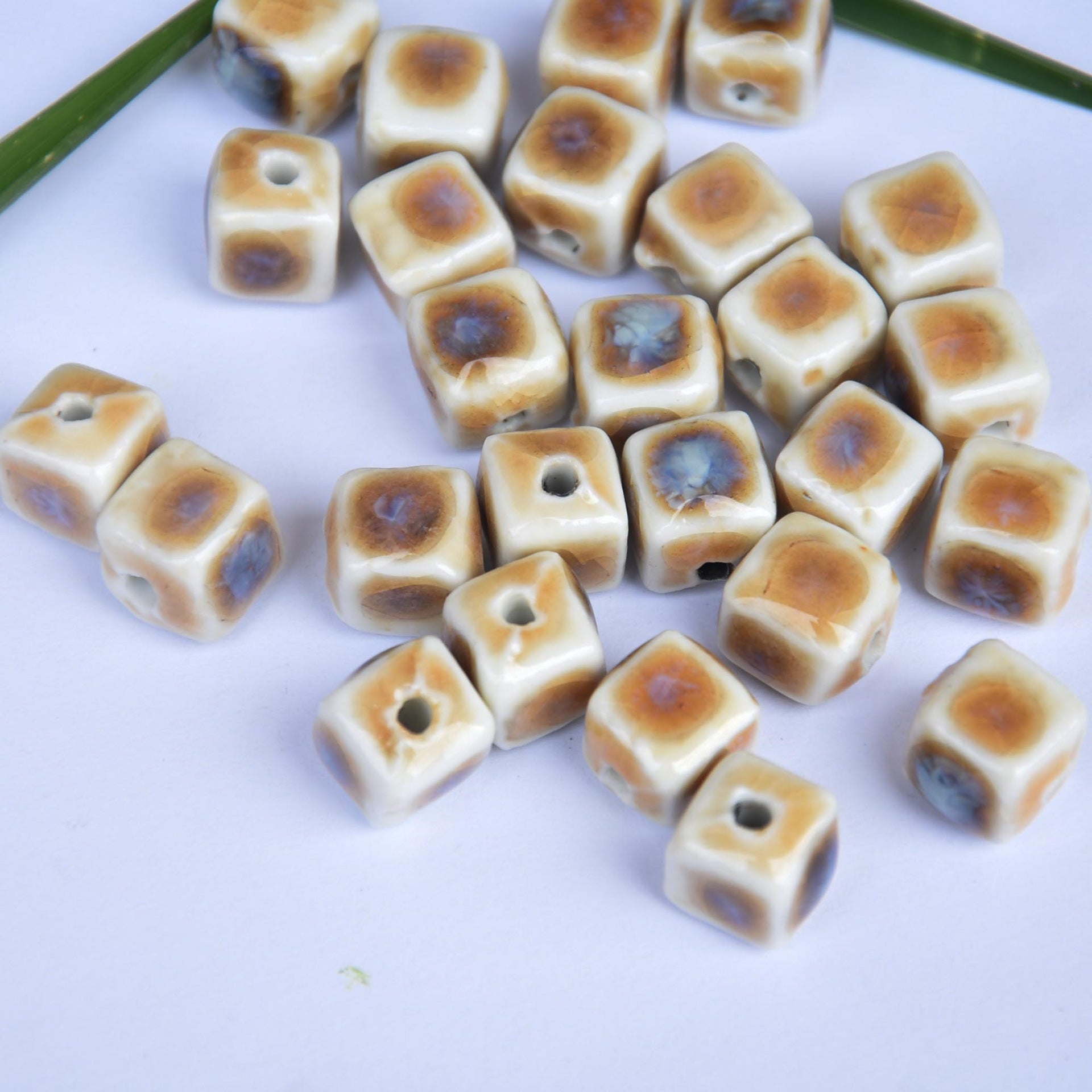 10mm square ceramic beads, cream with blue and tan prairie design, scattered pieces