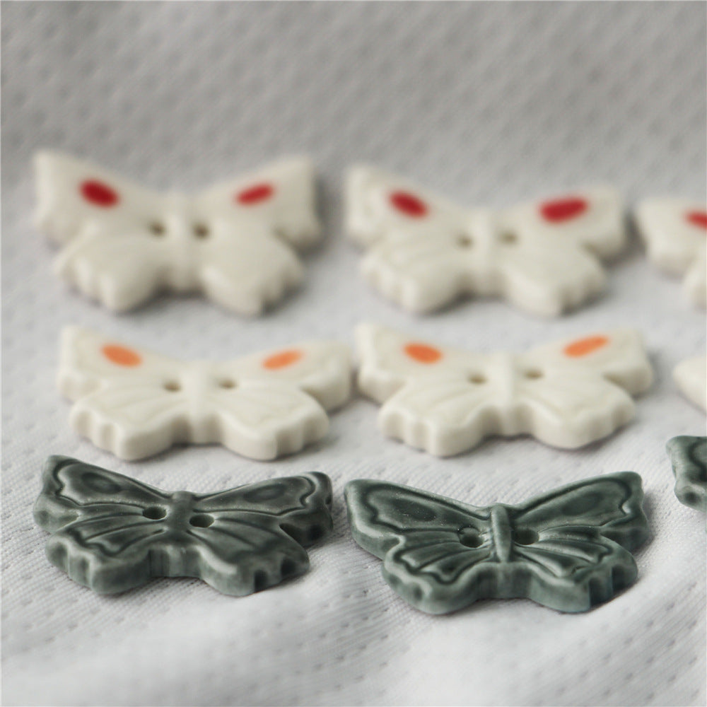 2-hole ceramic butterfly buttons, white with red spots and dark gray wings