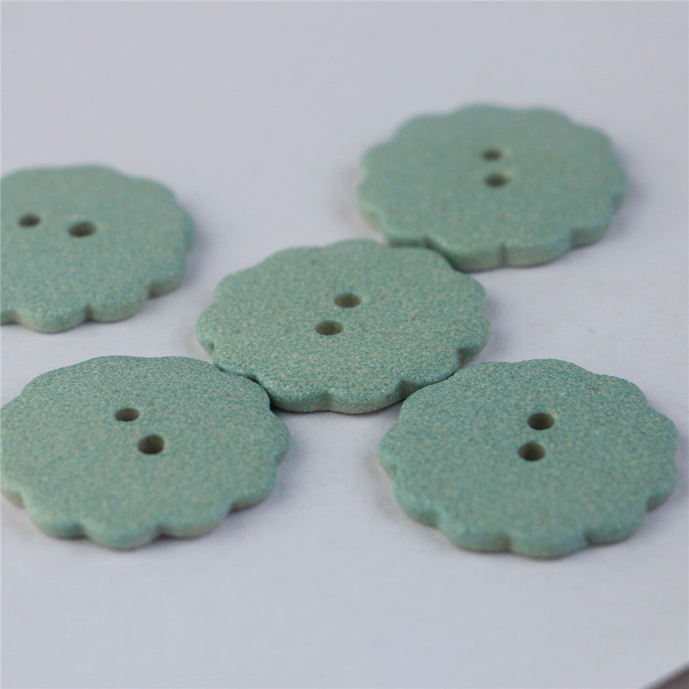 Matte light blue ceramic gear buttons, 2-hole, flat lay