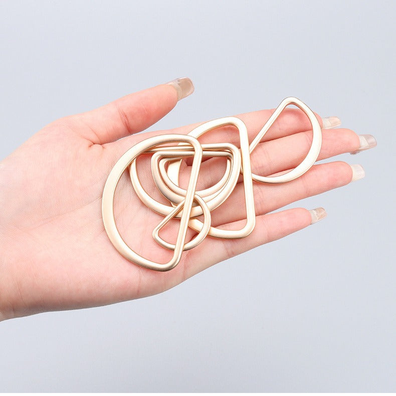 Hand-held set of gold 20–50mm D-ring metal belt bag adjustment buckles