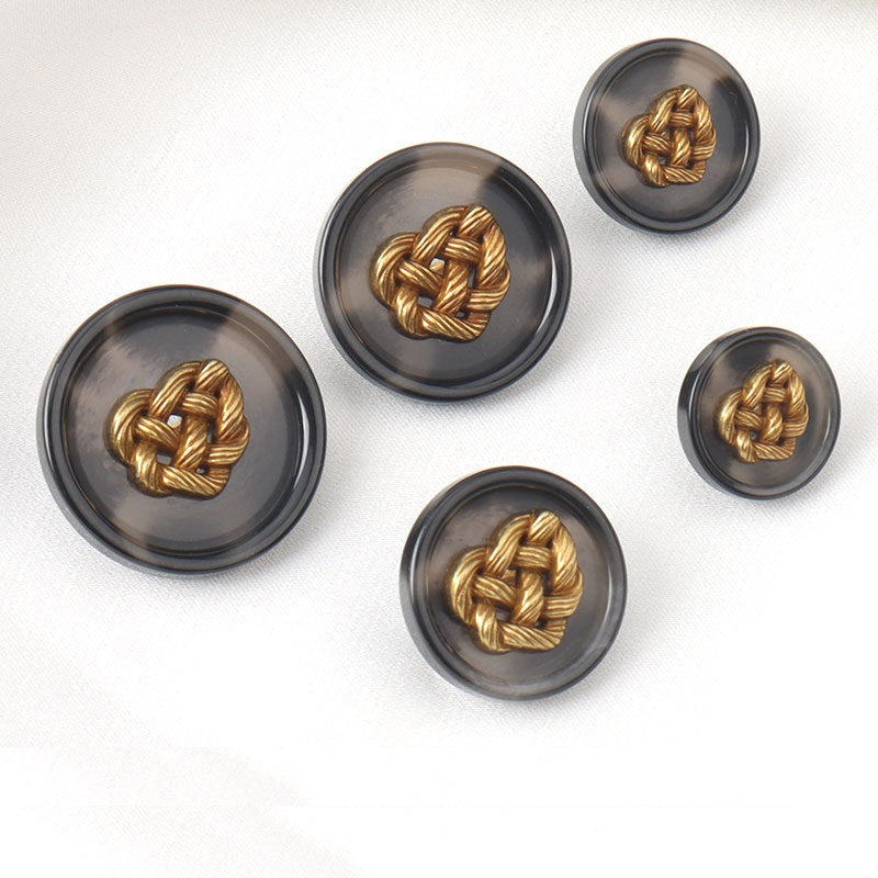 Five round dark resin buttons with gold woven heart metal designs