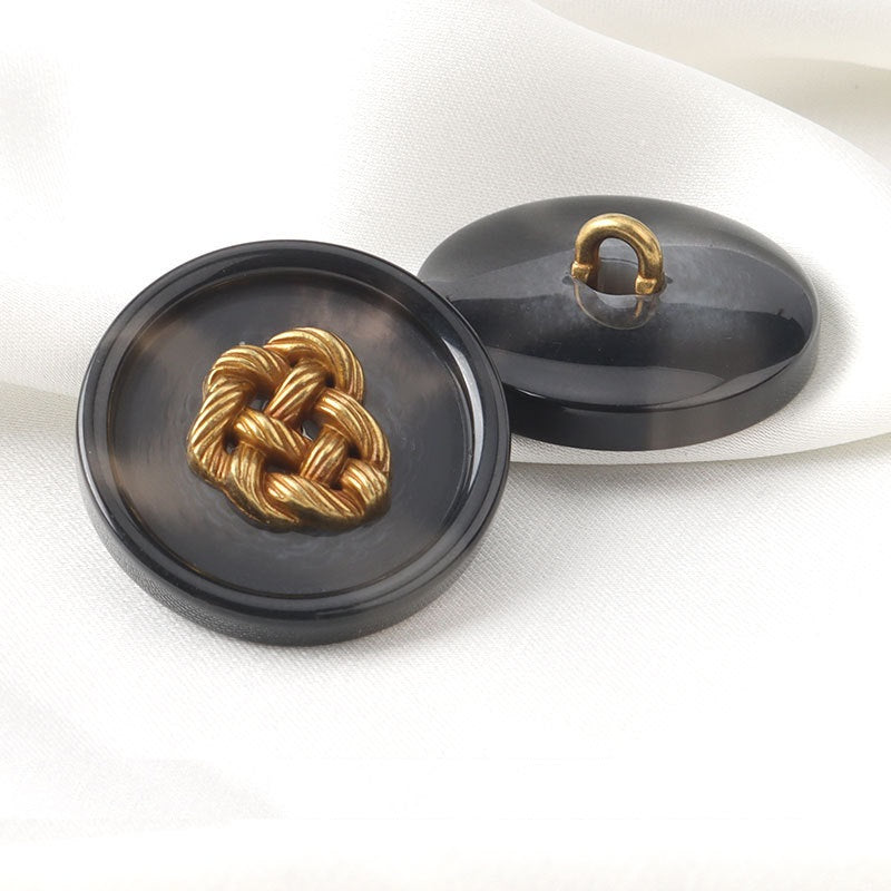 Round dark resin button with gold woven heart and loop shank on back