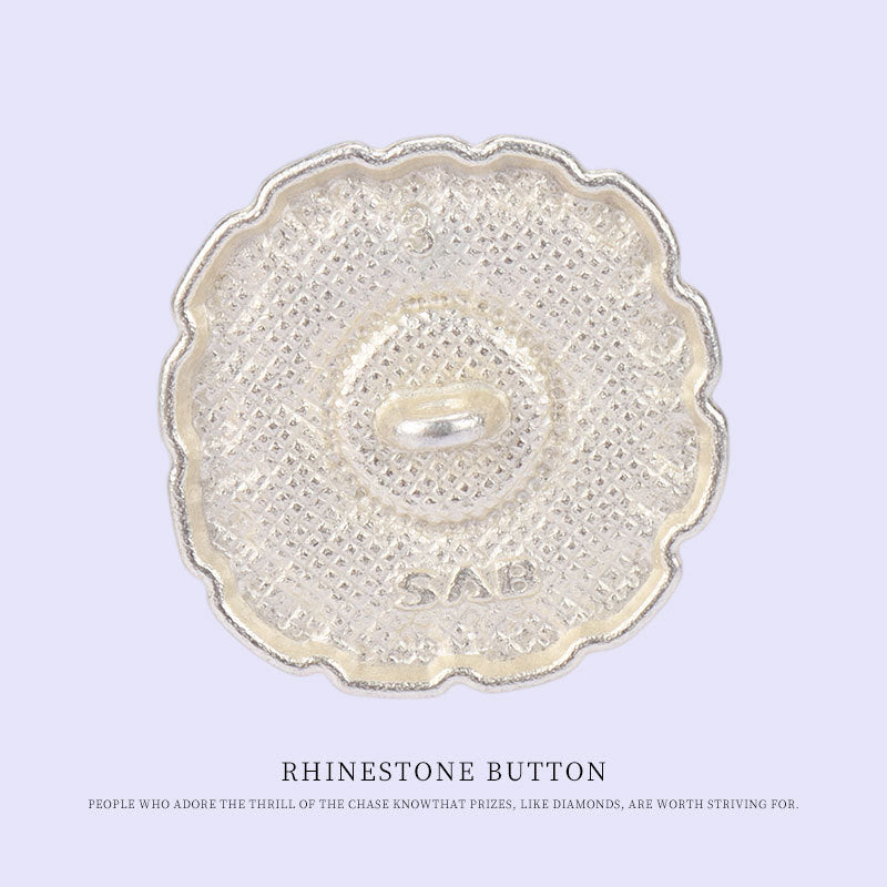 Matt silver metal back of pearl shank button, round with central loop and textured finish