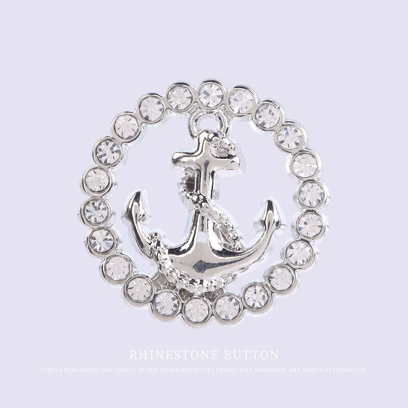 Round rhinestone button with silver-tone anchor motif and metal shank, circular ring