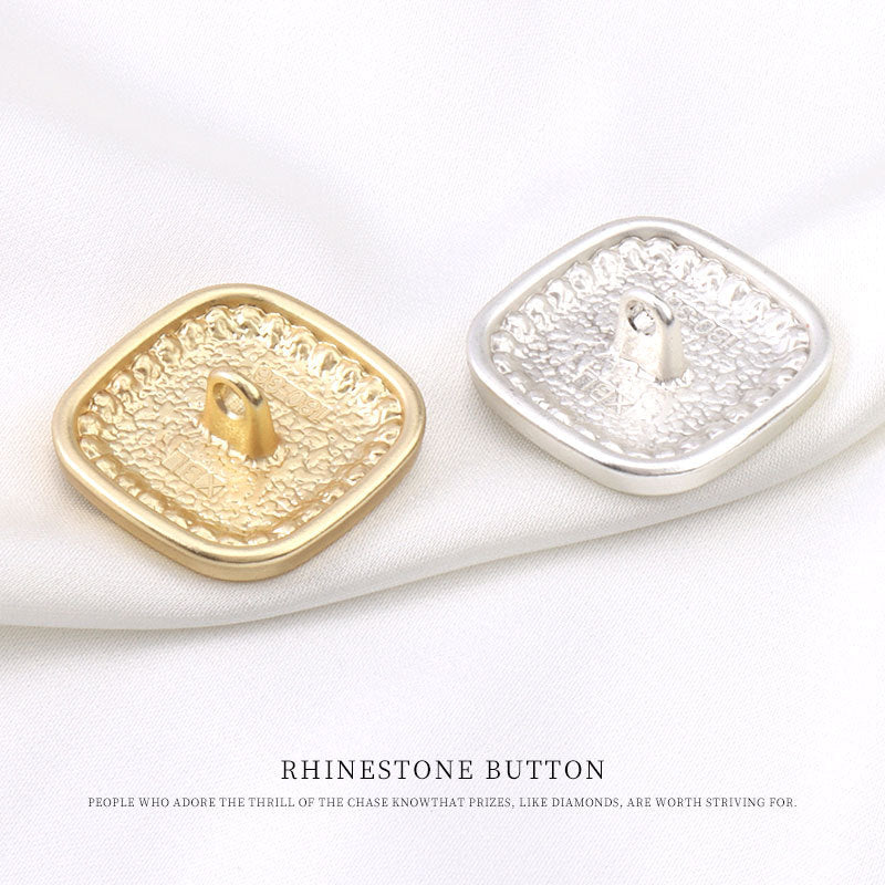Gold and silver square rhinestone buttons with visible metal shank and floral design