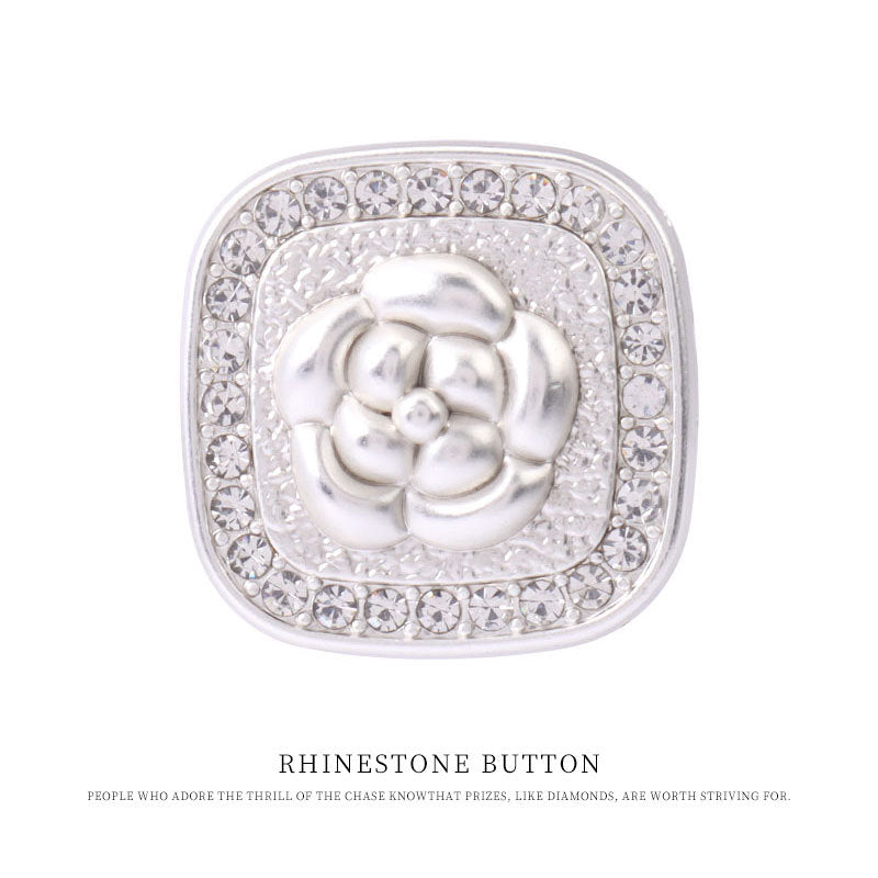 Close-up silver square rhinestone coat button with metal shank and floral motif