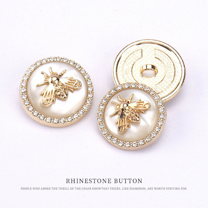 Round bee buttons, front with rhinestone border; back shows metal loop shank