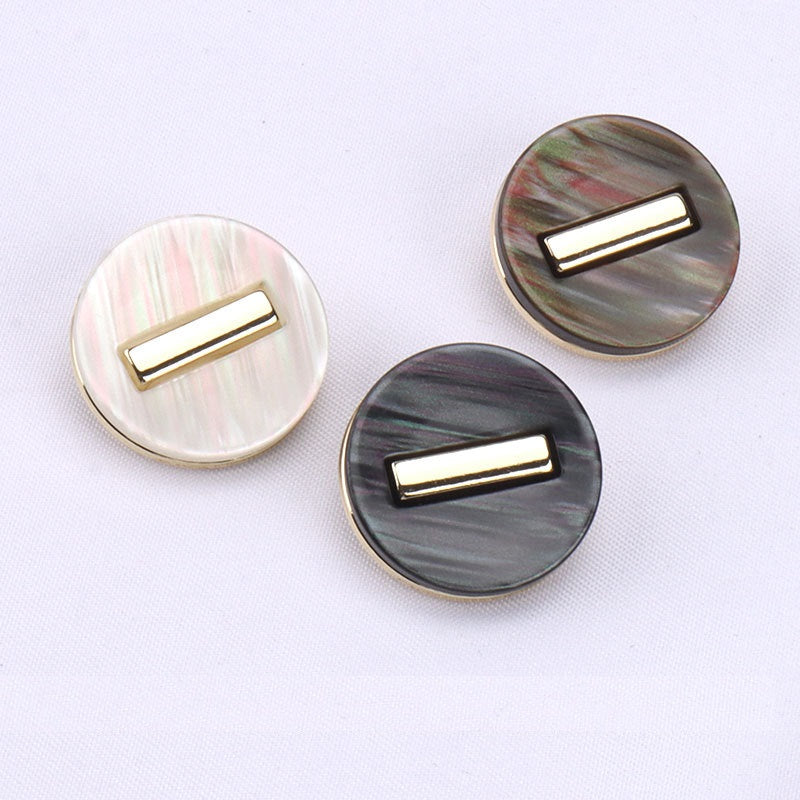 Three round resin shank buttons: white, dark, and brown with gold-tone frames