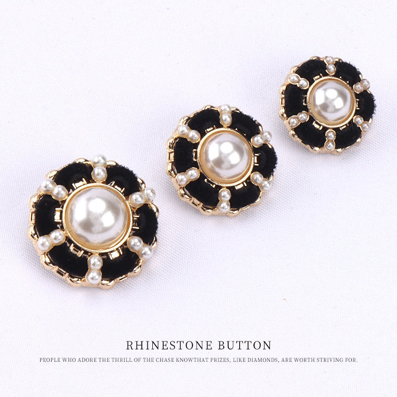 Three pearl shank buttons: black velvet, gold rim, round pearl centers.