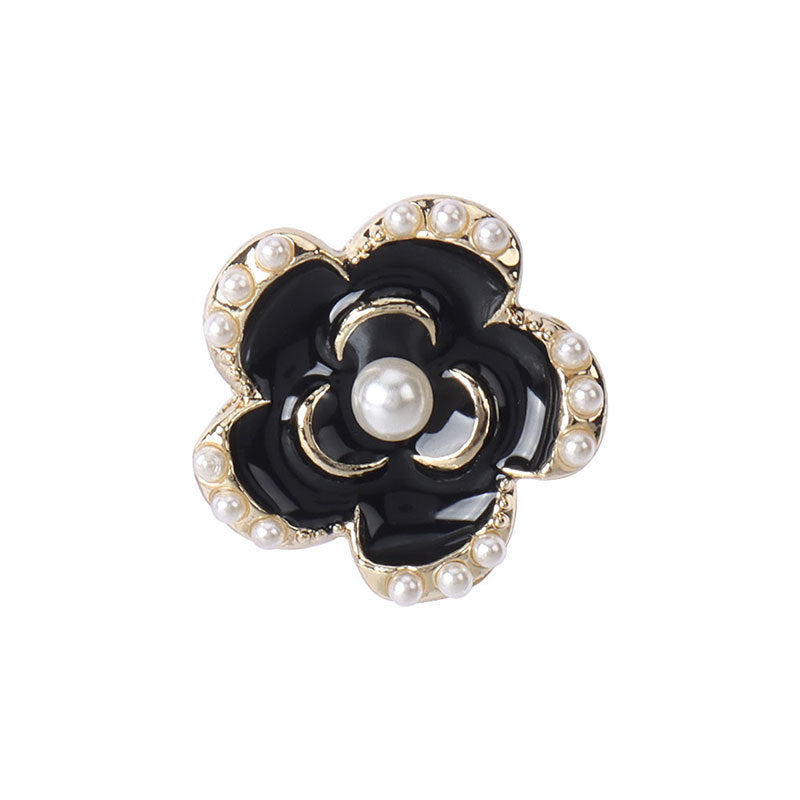 Black enamel floral coat button with gold edging and pearl-like studs, 18–23 mm