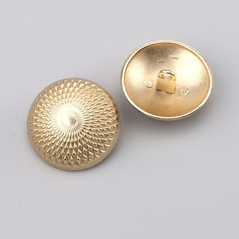 Gold metal button with textured sunburst front and visible underside shank
