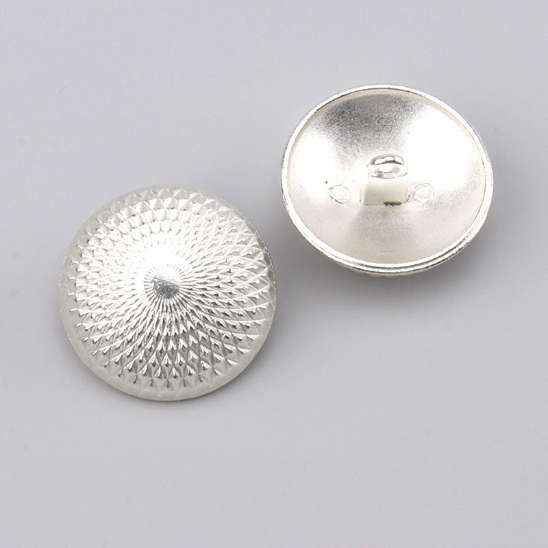 Silver-white metal button with sunburst texture front and visible underside shank