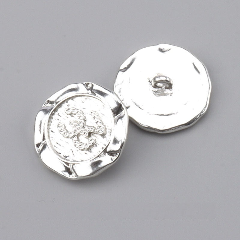 Silver metal button with shank back, ornate engraved front