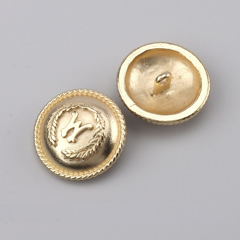 Gold metal button fronts with leaf wreath and one matching back with shank