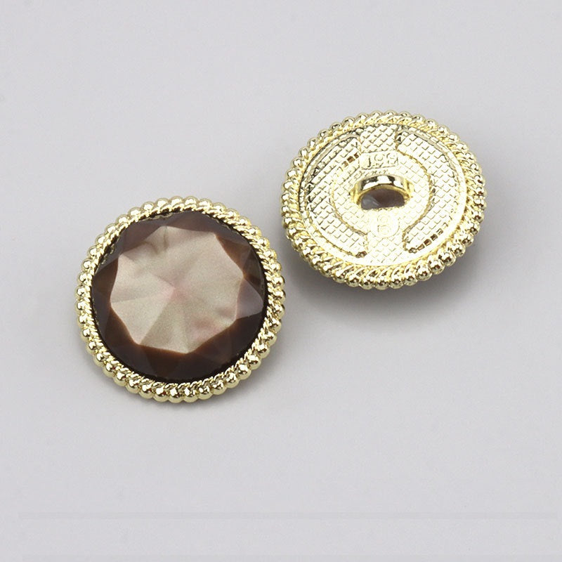 Brown round resin button with gold border and alloy shank; faceted front (back shown)