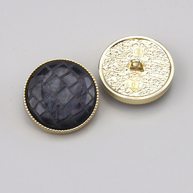 Black check resin shank button front with gold-tone backside