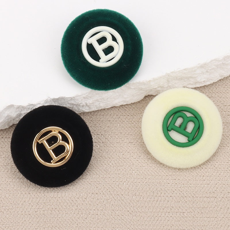 Set of flocked round “B” buttons: dark green with white, black with gold, cream with green