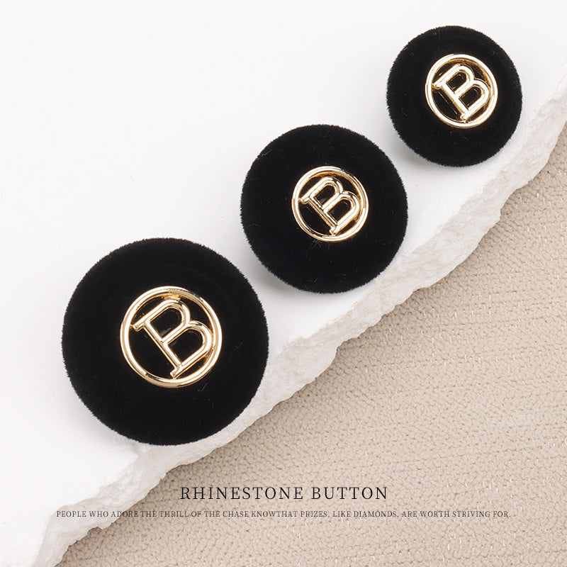 Flocked round “B” buttons with shank, black fabric with gold letter “B”