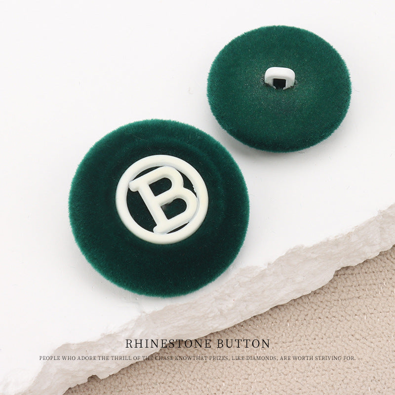 Dark green flocked round “B” buttons with shank, back shows mounting hole