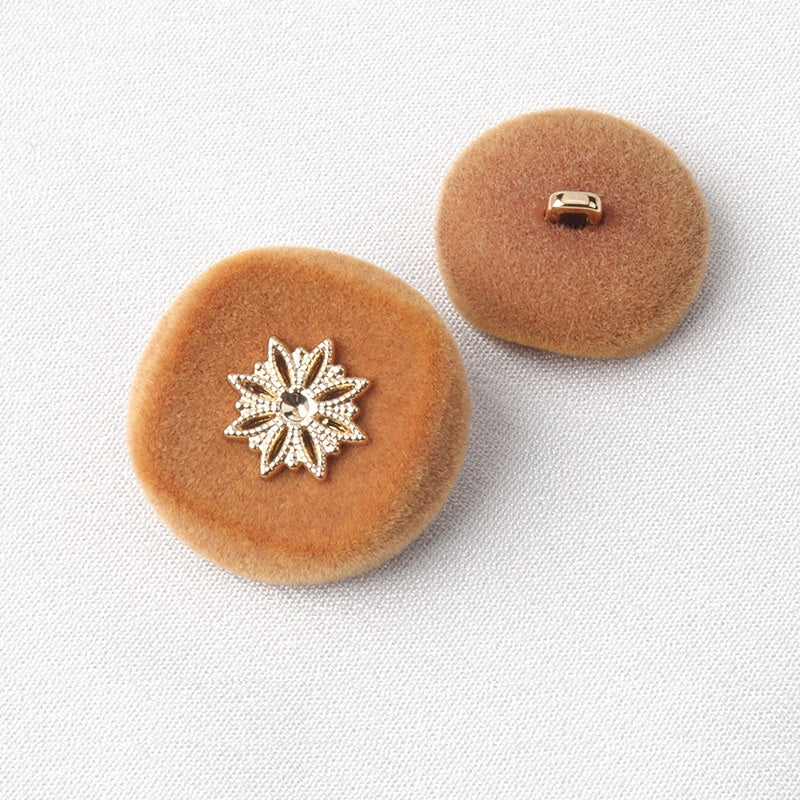 Brown flocked coat button with silver snowflake front and metal loop shank back