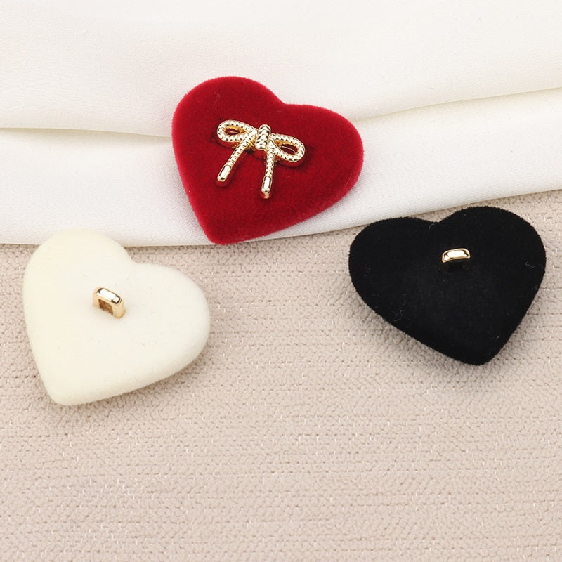 Heart-shaped velvet shank buttons, white red and black, showing flat loop backs