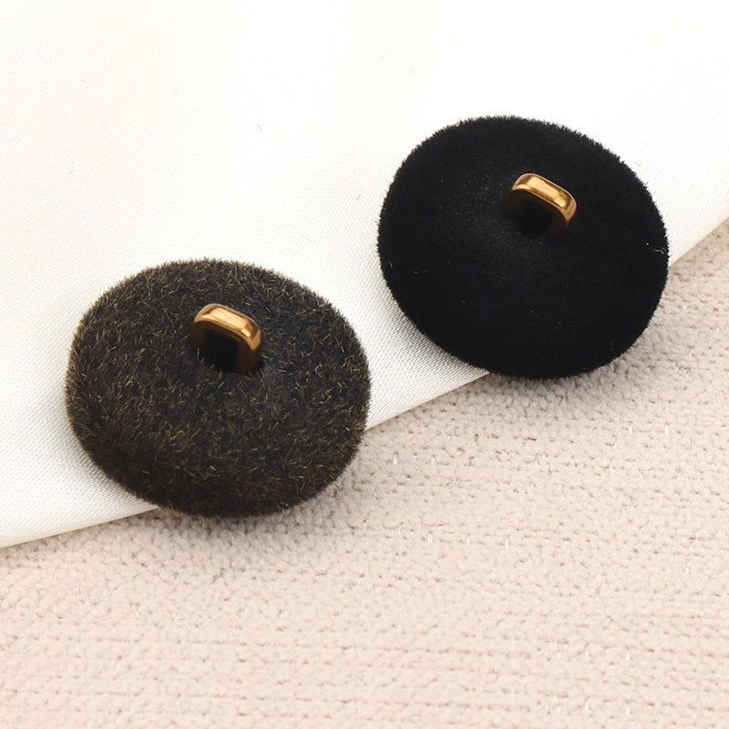 Dark flocked metal combination buttons, gold shank prongs, back view
