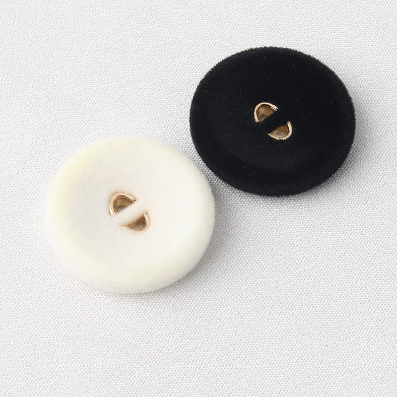 Flocked coat buttons, white and black, round with two gold-tone holes