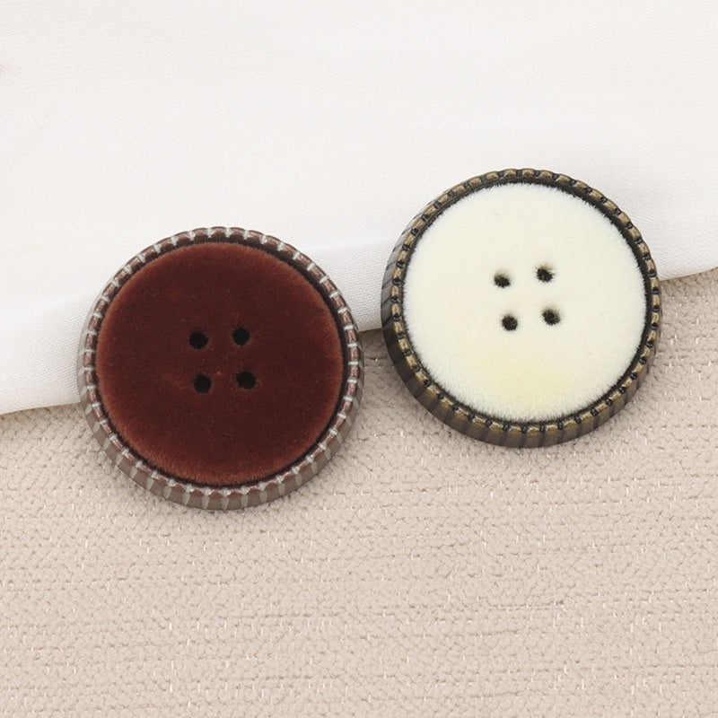 Two round coat buttons with shanks: dark brown and white flocked faces, 4-hole