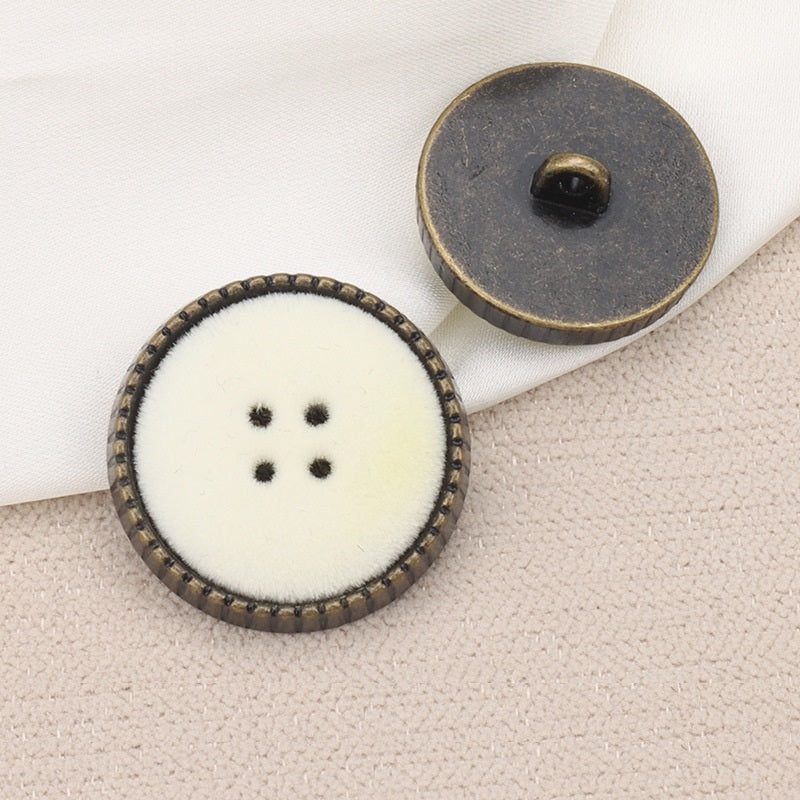 Round coat button with shank: white flocked face with 4-hole dots and metal back