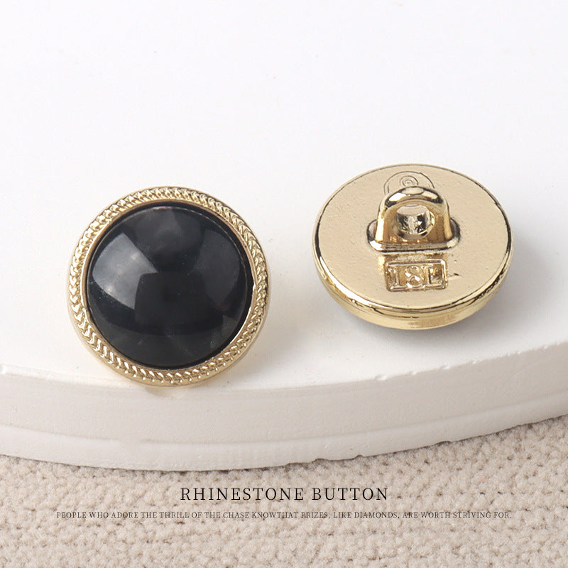 Black resin-look 11mm button with gold metal back and snap shank