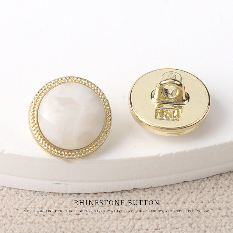 White resin-look 11mm button with gold metal back and snap shank